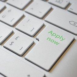 a part of a keyboard written "apply now"