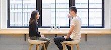 two people having a coffee by the window 