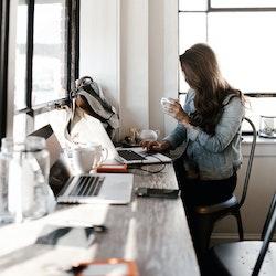 a person on the notebook drinking a coffee