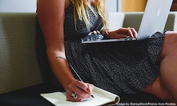 woman writing and typing
