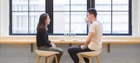 two people having a coffee by the window 