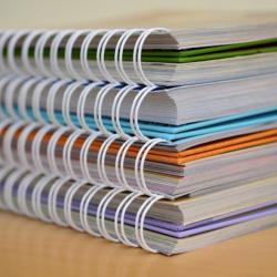 A stack of spiral notebooks.